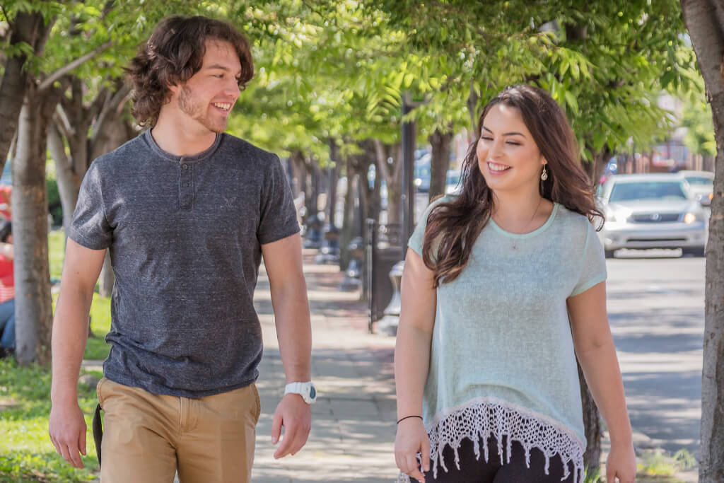 guy and girl walking on campus smiling